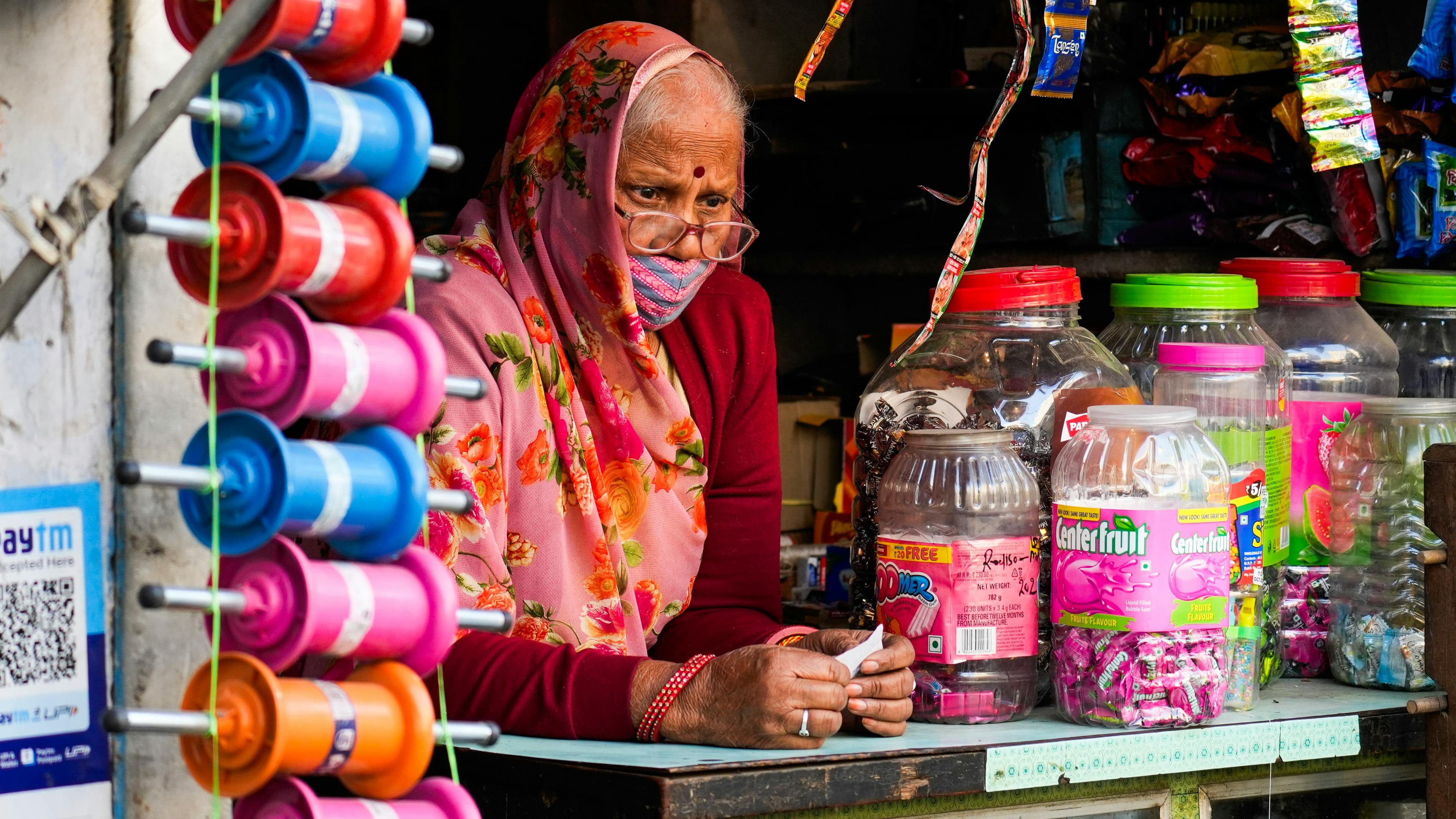 Guangzhou skyline at dusk showing the modern Zhujiang New Town skyline with the Canton Tower illuminated in colorful lights reflecting in the Pearl River with traditional buildings visible in the foreground